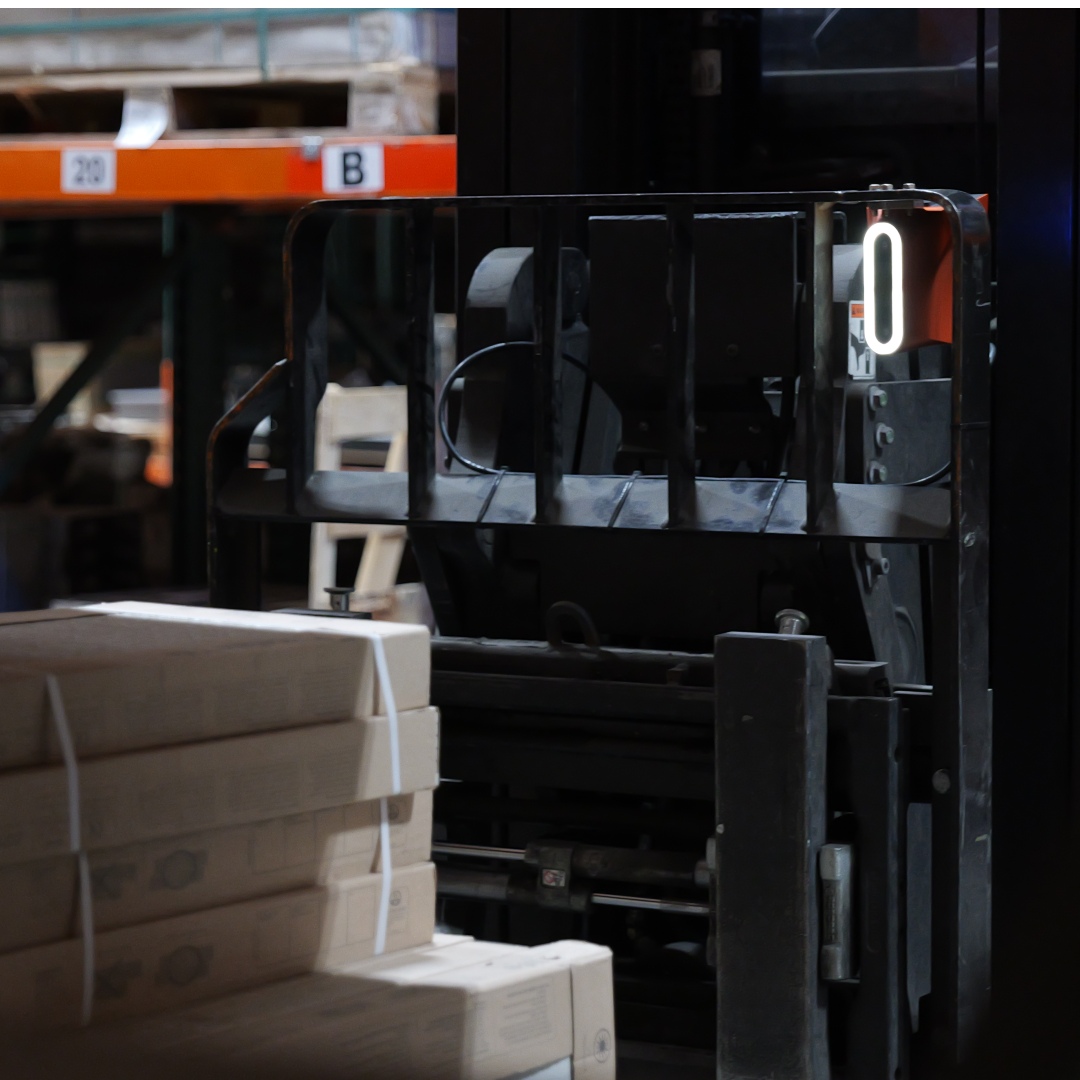 Corvus Trident mounted on a forklift in a warehouse, capturing pallet movement and barcode data during material handling.