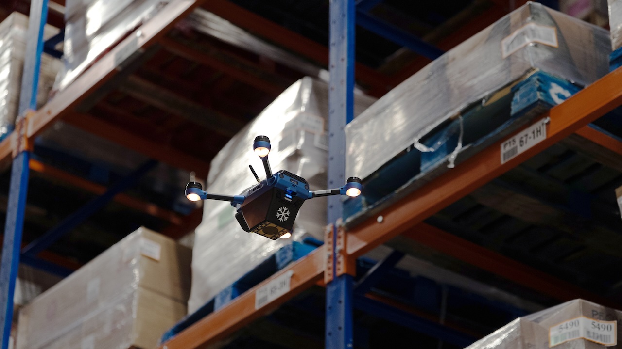 A Corvus One for Cold Chain drone flies near a rack of inventory as it scans inventory.